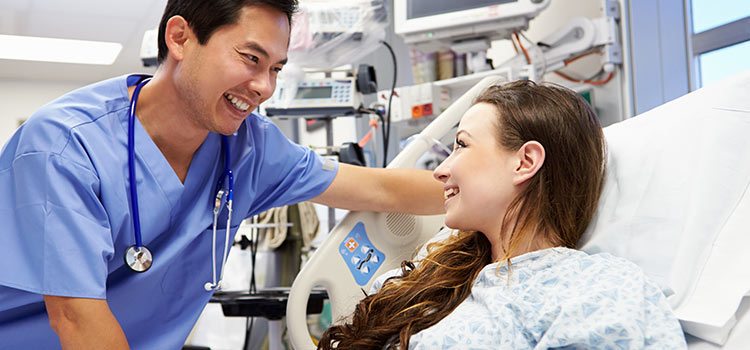 Nurse and teen-aged patient sharing a smile in a hospital setting