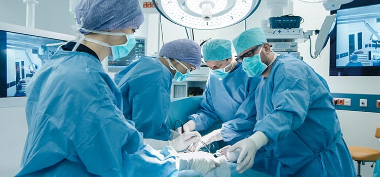 A surgical procedure taking place in an operating room