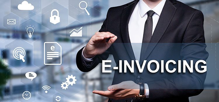 E-invoicing - business professional standing next a collection of digital-themed icons