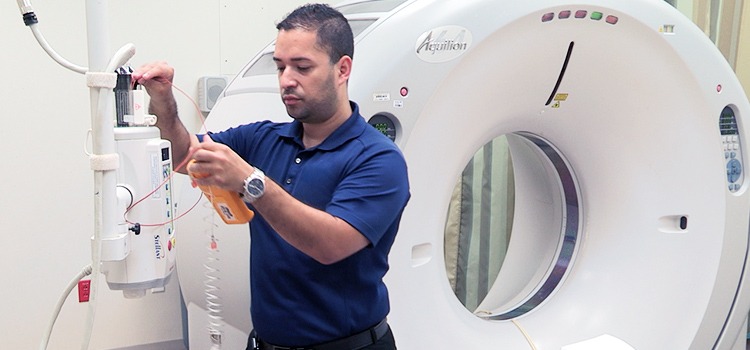 Biomed tech inspecting radiographic equipment