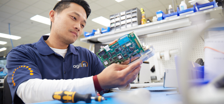 man inspecting a motherboard of a computer