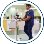 onsite equipment management - agiliti employee delivering ventilator to patient room